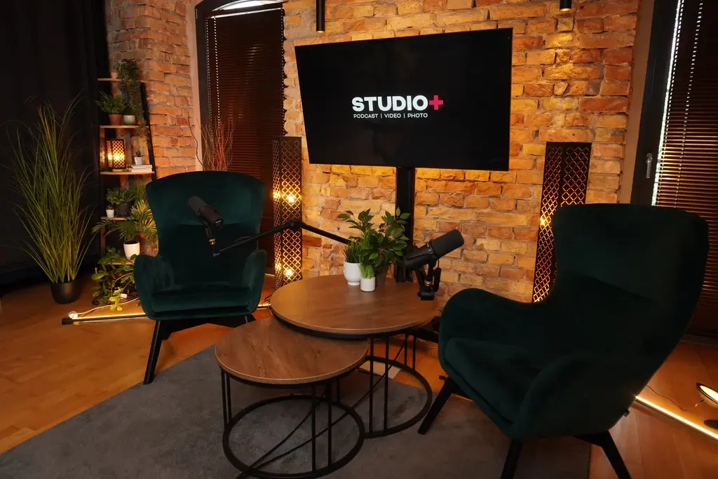 Fotelos beszélgetős díszlet a STUDIO+ stúdióban két zöld fotellel, kerek asztallal és mikrofonokkal